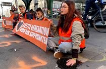 Last Generation activists block a road amid a protest in Berlin.