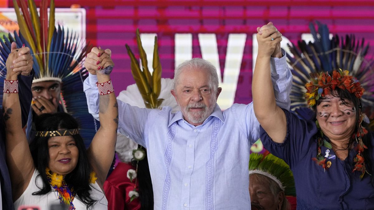 Brazilian President Luiz Inacio Lula da Silva stands between Indigenous Peoples Minister Sonia Guajajara, and National Indigenous Foundation President Joenia Wapichana