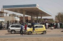 People line up at a gasoline station in Khartoum, Sudan, Saturday, April 29 as gunfire and heavy artillery fire continued despite the extension of a cease-fire.