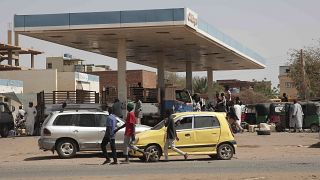 People line up at a gasoline station in Khartoum, Sudan, Saturday, April 29 as gunfire and heavy artillery fire continued despite the extension of a cease-fire.
