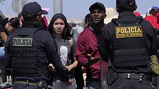 Venezuelan migrants speak with Peruvian police guarding the border with Chile in Tacna, Peru, Friday, April 28, 2023.