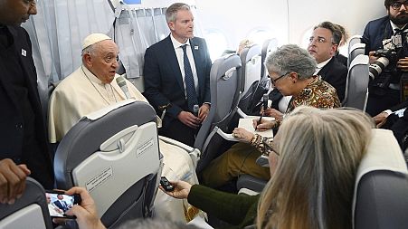 Pope Francis aboard a plan heading for Rome after his visit to Hungary April 30