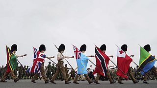 Guards carry flags from Commonwealth countries during a full tri-service and Commonwealth rehearsal at RAF Odiham in Hook, England, Sunday, April 30, 2023,
