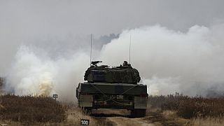 Ukrainian and Polish soldiers drive the Leopard 2 tank during a training at a military base and test range in Swietoszow, Poland, Monday, Feb. 13, 2023. 