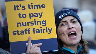 FILE: Nurses demonstrate towards passing traffic as they stand at a picket line outside the Royal Marsden Hospital in London, Thursday, Dec. 15, 2022