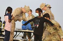 American nationals are searched by the U.S. soldiers before boarding a ship in Port Sudan, Sunday, April 30, 2023.