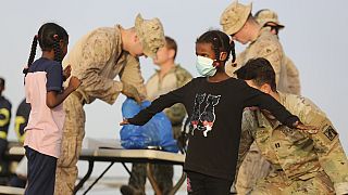 American nationals are searched by the U.S. soldiers before boarding a ship in Port Sudan, Sunday, April 30, 2023. 