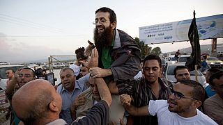 Palestinian Khader Adnan, center, is greeted by Palestinians after his release from an Israeli prison in the West Bank village of Arrabeh near Jenin, Sunday, July 12, 2015.