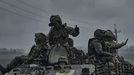 Ukrainian servicemen ride atop by an APC towards frontline positions near Vuhledar, Donetsk region, Ukraine, Monday, May 1, 2023. 