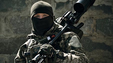 A Ukrainian army sniper looks on near Bakhmut, Donetsk region, Ukraine, Tuesday, May 2, 2023.