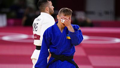 Ukrainian Artem Lesiuk competes in a men's 60kg repechage judo match at the 2020 Summer Olympics, Saturday.