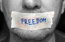 A man with freedom taped over his mouth. 