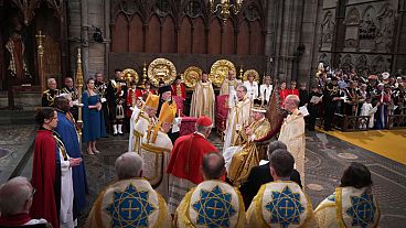 King Charles III surrounded by faith leaders during his coronation ceremony 