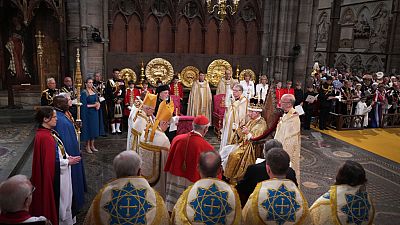King Charles III surrounded by faith leaders during his coronation ceremony 