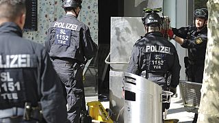 Police officers secure evidence during a raid in Saarlouis, Germany
