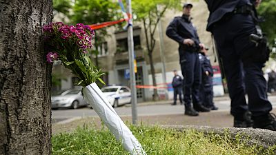 Flowers for victims are laid outside the Vladislav Ribnikar school in Belgrade, Serbia, Wednesday, May 3, 2023. 