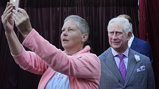 "Say cheese!" A woman photographs herself with a wax figure of King Charles III in the forecourt of the Queen Victoria Building in Sydney, Wednesday, May 3, 2023.