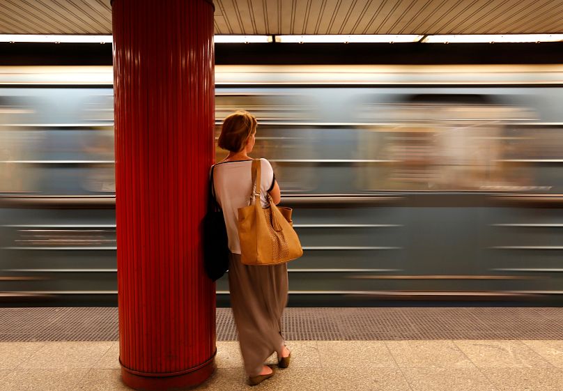 A commuter waits for a train at a subway station in Budapest, Hungary.