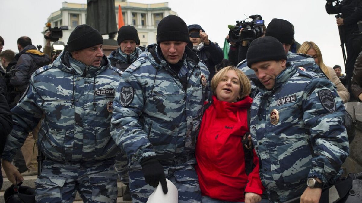 Police detain an anti-war protester in Moscow, Russia, Saturday, Oct. 17, 2015. 