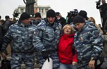 Police detain an anti-war protester in Moscow, Russia, Saturday, Oct. 17, 2015. 