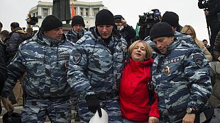 Police detain an anti-war protester in Moscow, Russia, Saturday, Oct. 17, 2015.