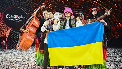 Members of the band "Kalush Orchestra" pose with the winner's trophy and Ukraine's flags at the Eurovision Song contest 2022 on May 14, 2022.