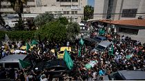 Palestinians carry the bodies of Hassan Qatnani, Moaz al-Masri and Ibrahim Jabr, draped in the Hamas militant group flags, during their funeral in Nablus
