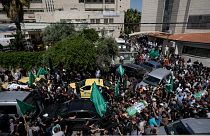 Palestinians carry the bodies of Hassan Qatnani, Moaz al-Masri and Ibrahim Jabr, draped in the Hamas militant group flags, during their funeral in Nablus
