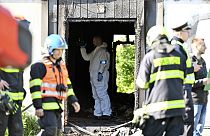 Firefighters and police investigators gather at the scene of a fatal fire in Plotni Street in Brno, Czech Republic, Thursday, May 4, 2023. 