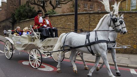 An early coronation parade? 'Charles and Camilla' take to the streets of London