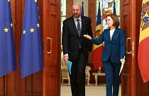 FILE: European Council President Charles Michel, left, walks with Moldova's President Maia Sandu after their meeting in Chisinau, Moldova, Tuesday, March 28, 2023.