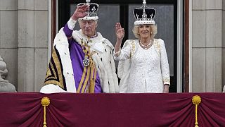 Britain's King Charles III and Queen Camilla wave to the crowds from the balcony of Buckingham Palace after the coronation ceremony in London, Saturday, May 6, 2023. 
