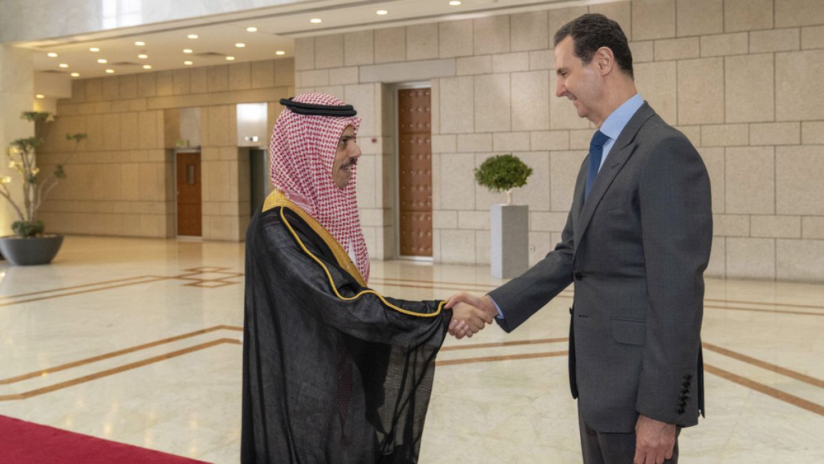 FILE - Syrian President Bashar Assad, right, welcomes Saudi Minster of Foreign Affairs Faisal bin Farhan, left, before their meeting in Damascus, Tuesday, April 18, 2023