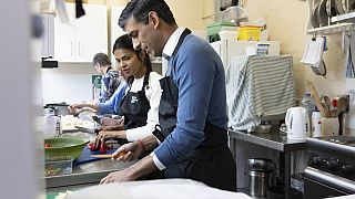 Britain's Prime Minister Rishi Sunak and his wife Akshata Murthy help prepare food as part of the Coronation Big Help Out, Rickmansworth, England, Monday May 8, 2023.