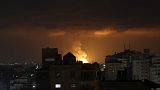 Smoke and flames rise above buildings after an Israeli airstrike in Gaza City