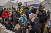 Ukrainian evacuees queue as they wait for further transport at the Medyka border crossing on March 29 2022
