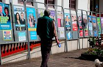 A man walks past campaign posters for the upcoming European elections in Hendaye, southwestern France, Wednesday, May 22, 2019.