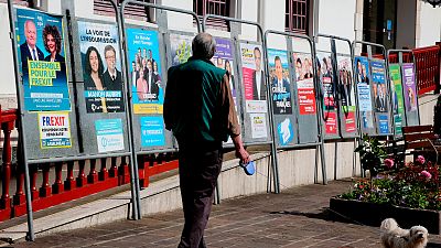 A man walks past campaign posters for the upcoming European elections in Hendaye, southwestern France, Wednesday, May 22, 2019.