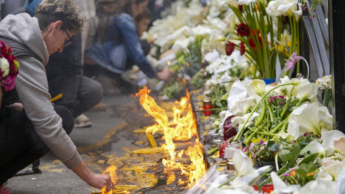 People light candles for the victims in front of the Vladimir Ribnikar school in Belgrade, Serbia. 4 May 2023