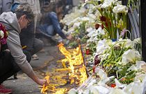 People light candles for the victims in front of the Vladimir Ribnikar school in Belgrade, Serbia. 4 May 2023
