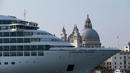 A cruise ship transits in the Giudecca canal in front of St. Mark's Square, in Venice, Italy, 2014.