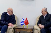  Turkey's Foreign Minister Mevlut Cavusoglu, right, talks with his Greek counterpart Nikos Dendias, in Adana, Turkey, Sunday, Feb. 12, 2023.