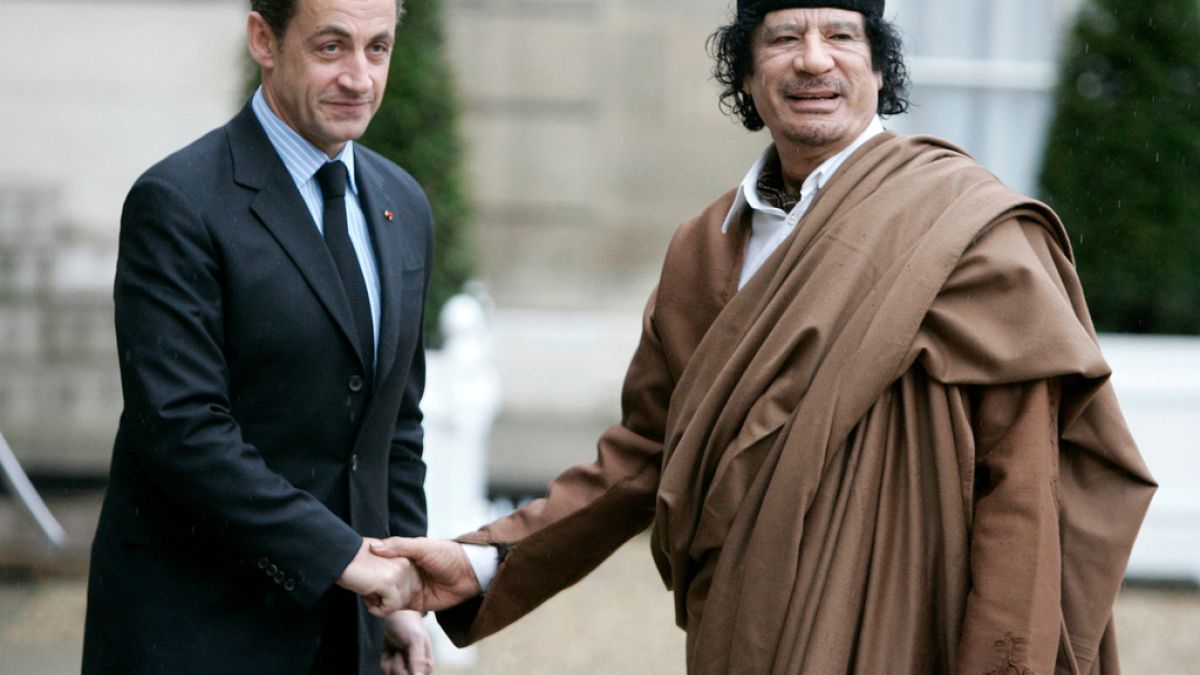 FILE: Former French President Nicolas Sarkozy welcomes Moammar Gaddafi to Paris, 10 December 2007.
