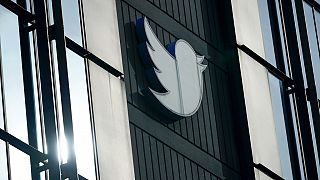 FILE - A Twitter logo hangs outside the company's offices in San Francisco, Dec. 19, 2022.