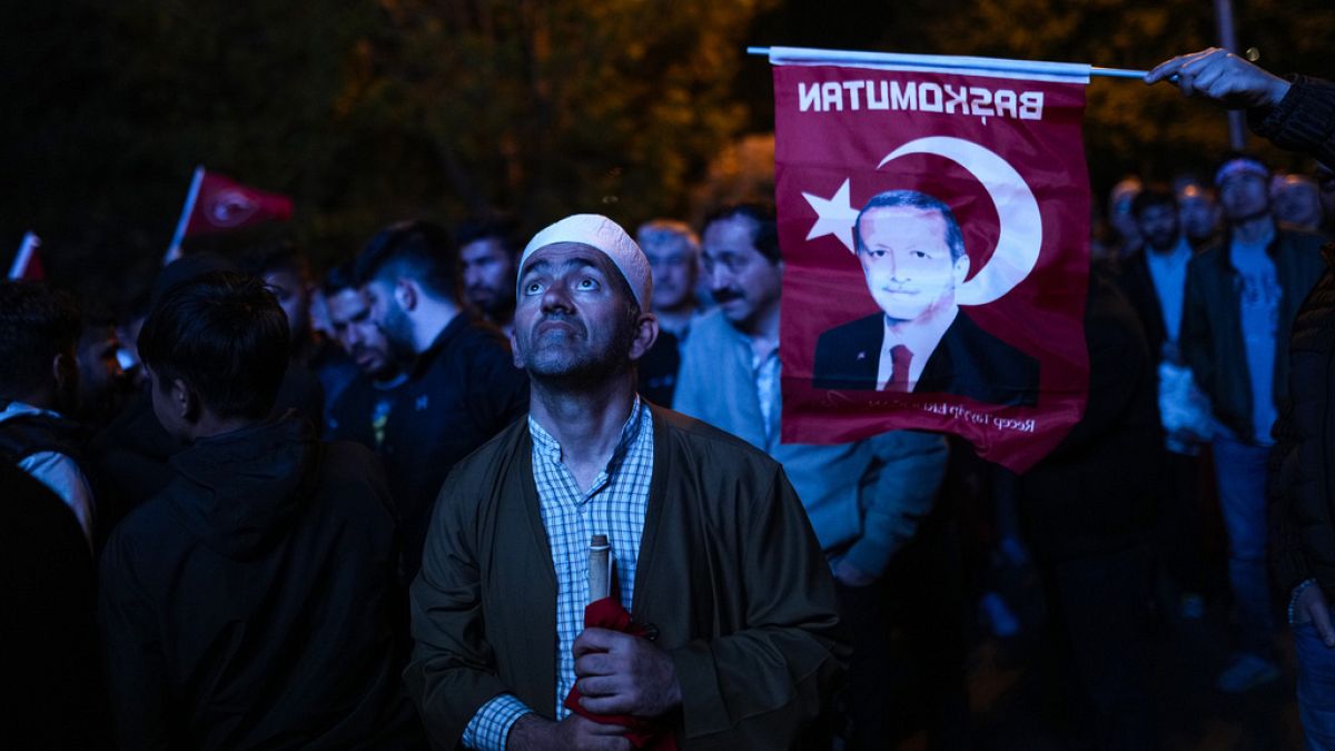 Supporters of Turkish President Recep Tayyip Erdogan watch news on a giant screen outside AKP (Justice and Development Party) office Istanbul, Turkey, Sunday, May 14, 2023