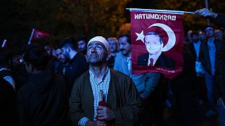 Supporters of Turkish President Recep Tayyip Erdogan watch news on a giant screen outside AKP (Justice and Development Party) office Istanbul, Turkey, Sunday, May 14, 2023