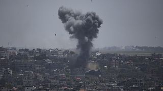 Smoke rises from an explosion caused by an Israeli airstrike in the Gaza Strip, Saturday, May 13, 2023