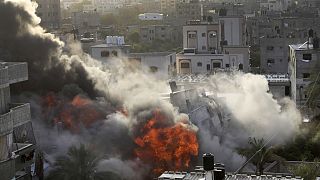 Smoke and fire rise from an explosion caused by an Israeli airstrike targeting a building in Gaza, Saturday, May 13, 2023. 