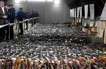 Serbian President Aleksandar Vucic, left, inspects weapons collected near the city of Smederevo