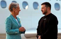 Ukrainian President Volodymyr Zelenskyy is welcomed by French Prime minister Elisabeth Borne upon his arrival at Villacoublay Air Base, southwest of Paris, 14 May, 2023